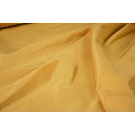 Tessuto unito di colore giallo che mima l'effetto della seta